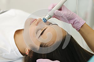 Close-up of woman getting facial hydro microdermabrasion peeling treatment. Female at cosmetic beauty spa slinic. Hydra