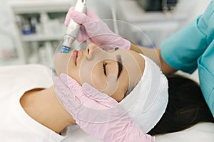 Close-up of woman getting facial hydro microdermabrasion peeling treatment. Female at cosmetic beauty spa slinic. Hydra