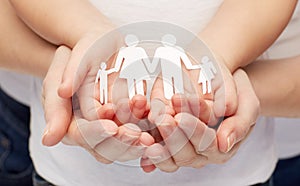 Close up of woman and girl hands with paper family