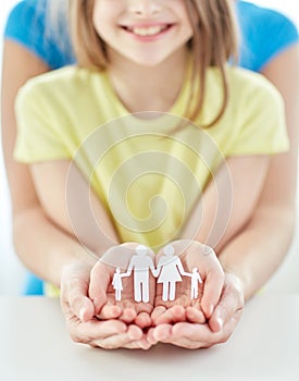 Close up of woman and girl hands with paper family