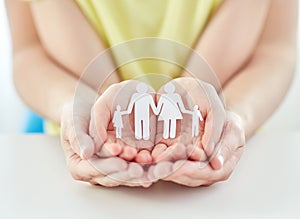 Close up of woman and girl hands with paper family