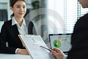 Close up of woman give resume to hr manager for job interview in office. Female sit on table and discuss with human resources