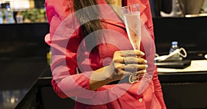 Close up of woman with glass of champagne toast at the office party on corporate event
