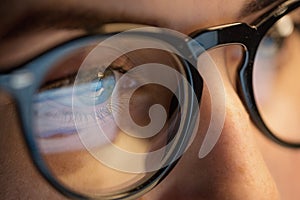 Close up of woman in glasses looking at screen