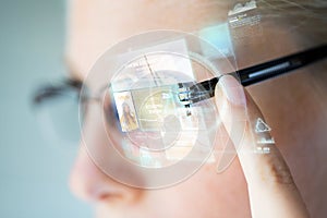 Close up of woman in glasses with virtual screen