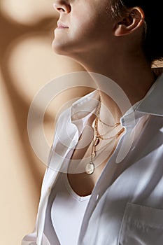 close up of woman with golden jewelry on her neck