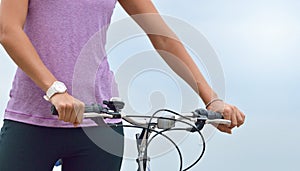 Close up woman hand on the bicycle handlebars