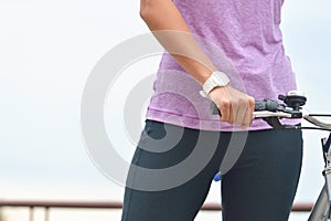 Close up woman hand on the bicycle handlebars