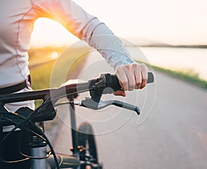 Close up woman hand on the bicycle handlebars