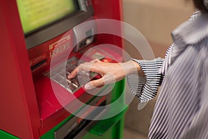 Close-up of woman hand entering PIN/pass code on ATM/bank machine keypad.