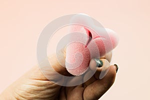 Close up of woman hand holding menstrual sponge tampon in packag