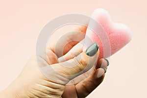 Close up of woman hand holding menstrual sponge tampon in packag