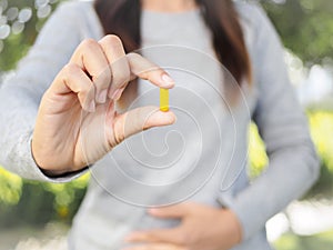 Close up of woman hand holding pills.