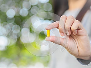 Close up of woman hand holding pills.