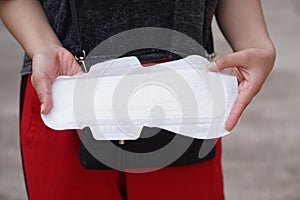 Close up woman hand is holding sanitary napkin