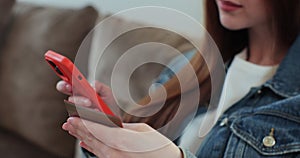 Close up of woman hand holding smartphone and credit card doing online shopping at home. Smart phone e-banking service