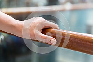 Close up of woman hand holding to railing