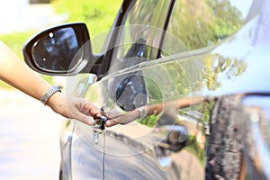 Close up woman hand opening the car