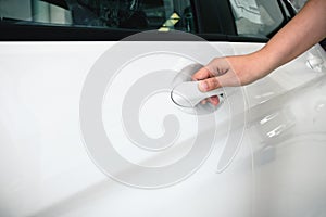 Close up woman hand opening a car door