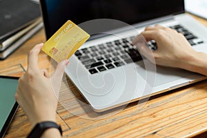 Close up of woman hand paying online order on laptop