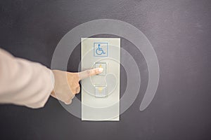 Close up woman hand is press elevator button