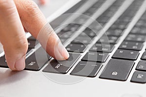 Close up of Woman hand pressing Enter button on laptop