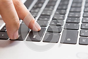 Close up of Woman hand pressing Enter button on laptop