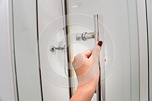 Close up woman hand pull the shower door in luxury bathroom