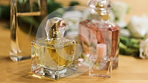 Close up of woman hand putting small glass bottle of perfume on a table. Concept. Bottles of fragrances on a female photo