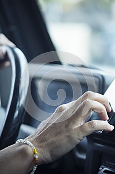 Close up of woman hand setting the gps online navigator on the phone while drive - people and travel with technology help to find