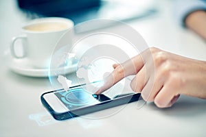 Close up of woman hand with smartphone and globe