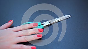 Close up of woman hand taking scissors