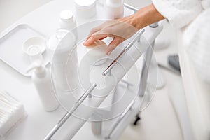 Close up of woman hand touching a jar of cream