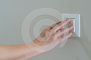 Close up of woman hand  for turns off light switches