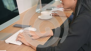 Close up the woman hand typing message on keyboard of PC computer on desk in office