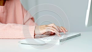 Close up of woman hand typing white keyboard computer, work from home, study at home, people and online technology, internet of