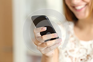 Close up of a woman hand using a smart phone at home