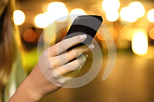 Close up of a woman hand using a smart phone in the night