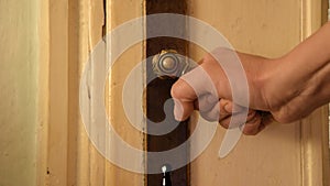 Close up of woman hand wants to open the old close door