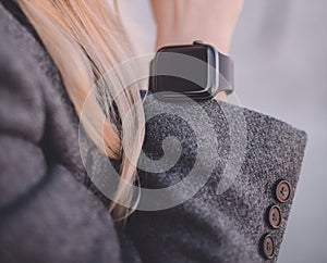 Close-up of woman hand, wearing in digital smart watch, outdoor