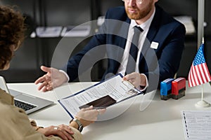 Close up of woman handing visa application