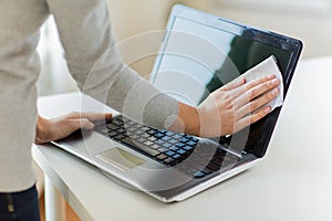 Close up of woman hands cleaning laptop screen