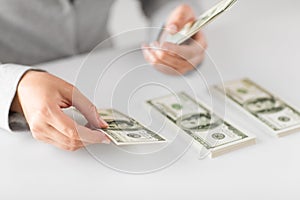 Close up of woman hands counting us dollar money