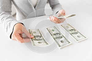 Close up of woman hands counting us dollar money