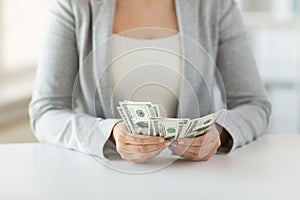 Close up of woman hands counting us dollar money