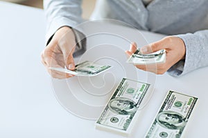 Close up of woman hands counting us dollar money