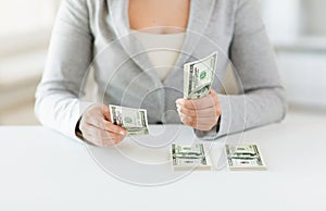 Close up of woman hands counting us dollar money