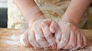 Close up of woman hands crumple dough