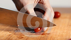 Close up of woman hands cutting cherry tomatoes, graded 4k