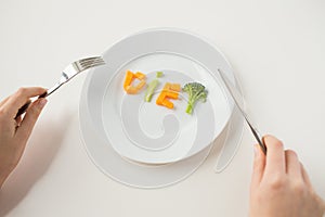 Close up of woman hands eating vegetables